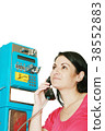 Young woman standing at phonebox 38552883