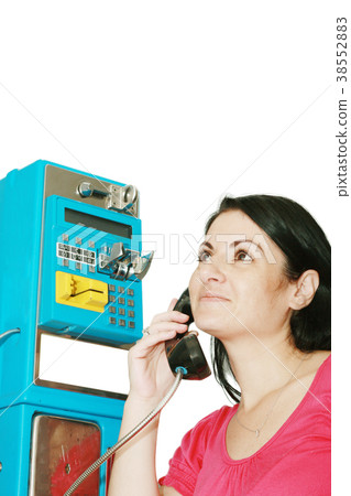 Young woman standing at phonebox Young woman standing at phonebox 38552883