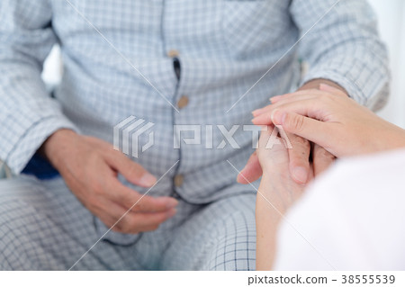 Holding hands Touching hands Young nurse and grandpa Retirement home Day care center Wheelchair Holding hands Touching hands Young nurse and grandpa Retirement home Day care center Wheelchair 38555539