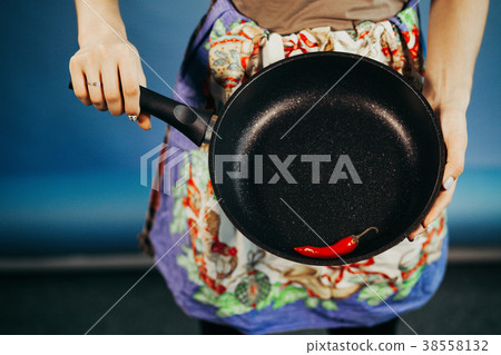 The girl with a frying pan. Are red sharp Chile 38558132