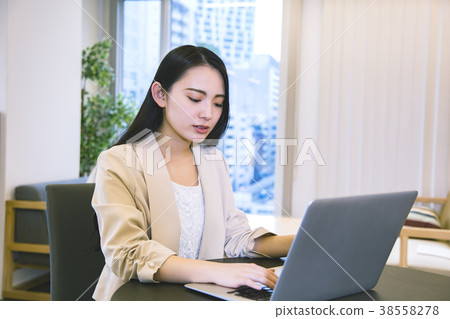 A young woman working at a share office A young woman working at a share office 38558278