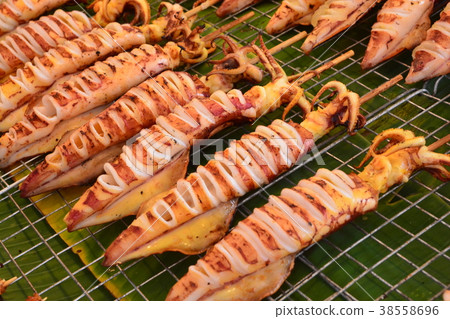 Grilled Squid at street food in Thailand. Grilled Squid at street food in Thailand. 38558696