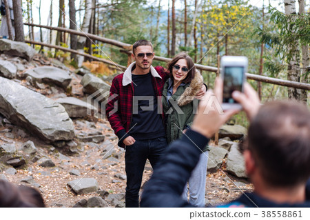 guy and girl are posing on camera guy and girl are posing on camera 38558861