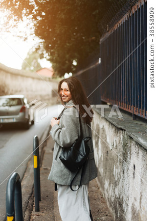 Beautiful young girl on a narrow street. 38558909