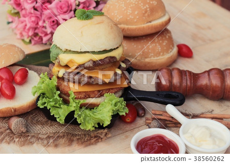 Double hamburger with double cheese is tasty. 38560262