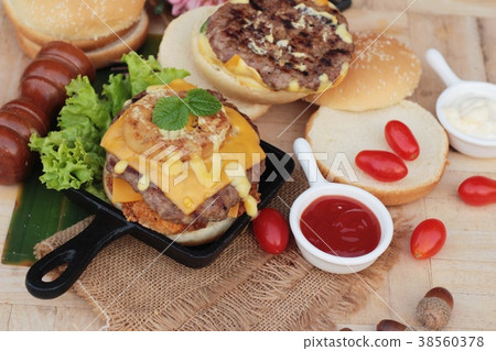 Double hamburger with double cheese is tasty. 38560378