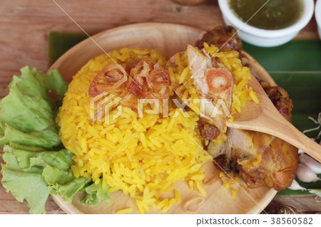 chicken biryani with rice delicious and sauce. 38560582