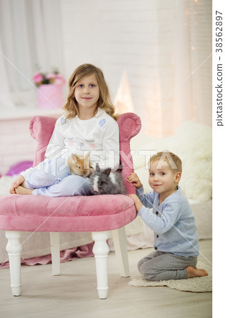 Pretty little girl with her brother at home are Pretty little girl with her brother at home are 38562897