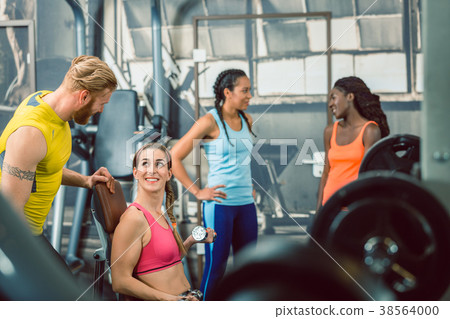 Side view of a handsome personal trainer guiding Side view of a handsome personal trainer guiding 38564000