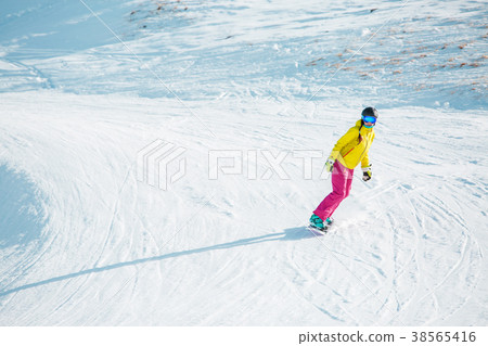 Picture of sports woman snowboarding from mountain Picture of sports woman snowboarding from mountain 38565416