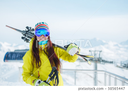 Sports woman in mask with skis on her shoulder on Sports woman in mask with skis on her shoulder on 38565447