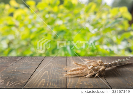 Natural background with wheat on wooden board. Natural background with wheat on wooden board. 38567349