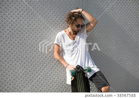 Stylish man in sunglasses with skateboard. Stylish man in sunglasses with skateboard. 38567588