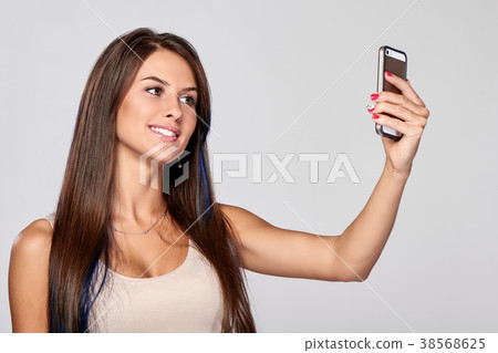 Woman taking self portrait Woman taking self portrait 38568625