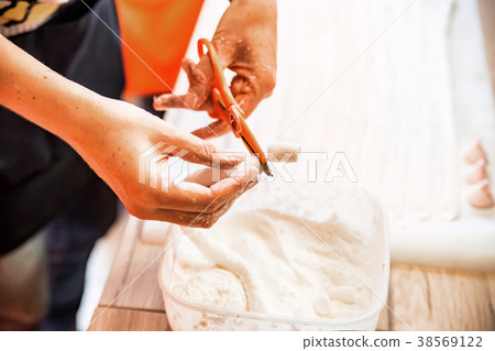 Woman hands cut white marshmallow Woman hands cut white marshmallow 38569122