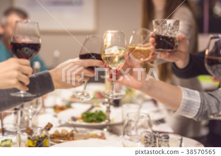 Blurred abstract background of clinking glasses of 38570565