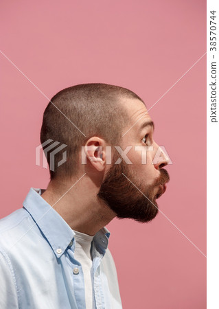 Isolated on pink young casual man kissing at 38570744