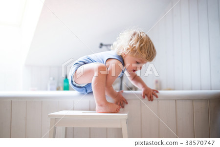 Toddler boy in a dangerous situation in the 38570747