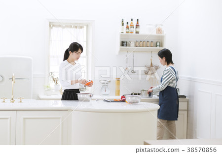 Mother and girl cooking Mother and girl cooking 38570856