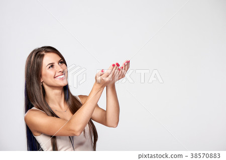 Woman catching something falling from the above Woman catching something falling from the above 38570883