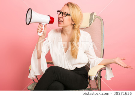 Angry businesswoman with loudspeaker Angry businesswoman with loudspeaker 38571636