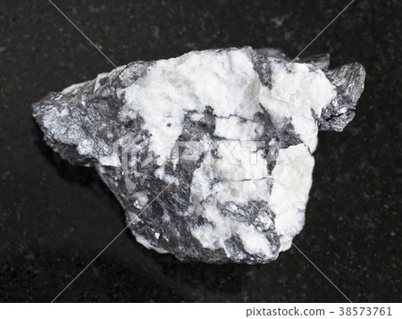 Bismuthinite vein in raw quartz stone on dark 38573761