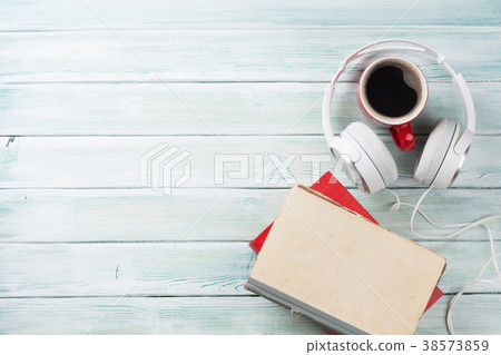 Audio book concept. Headphones, coffee and books Audio book concept. Headphones, coffee and books 38573859