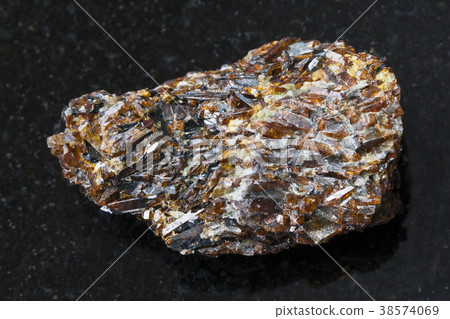 raw Titanite stone on dark background 38574069