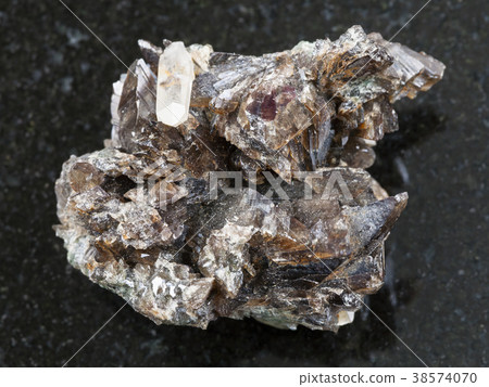rough crystals of axinite stone on dark background 38574070