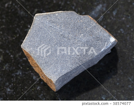 rough hyalobasalt (tachylite) stone on dark 38574077