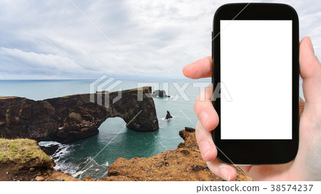 tourist photographs Dyrholaey cliff in Iceland tourist photographs Dyrholaey cliff in Iceland 38574237