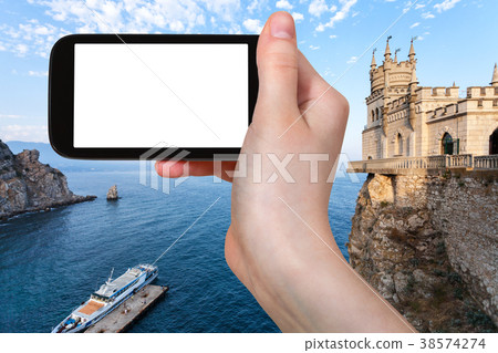 tourist photographs pier and Swallow's Nest Castle 38574274