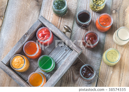 Assortment of sauces in the glass jars Assortment of sauces in the glass jars 38574335