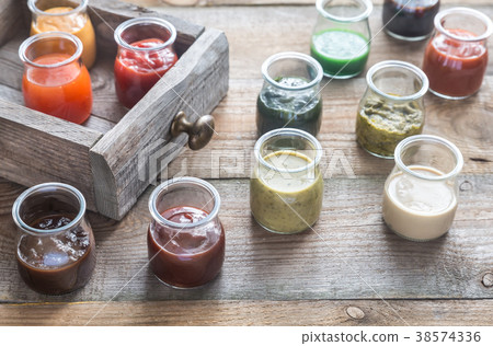Assortment of sauces in the glass jars 38574336
