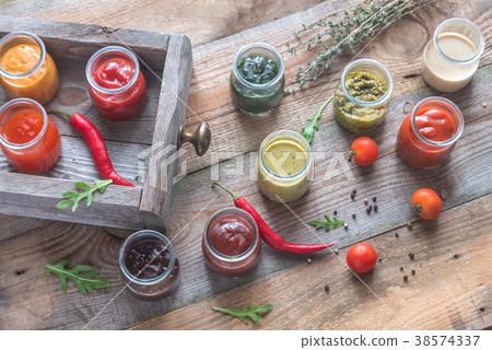 Assortment of sauces in the glass jars 38574337