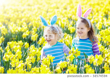 Kids with bunny ears on Easter egg hunt. Kids with bunny ears on Easter egg hunt. 38574594