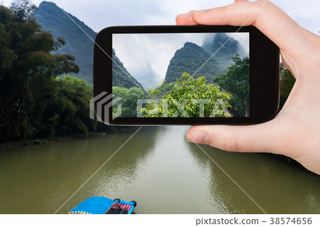 tourist photographs river and karst peaks 38574656