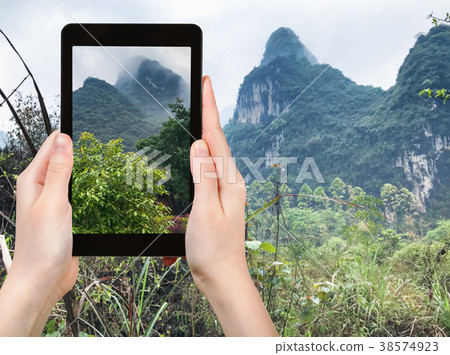 tourist photographs karst mountains in Yangshuo 38574923