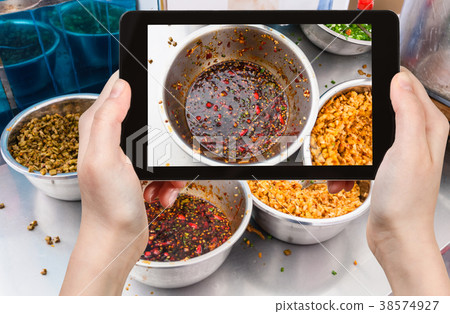 tourist photographs bowl with spicy sauce in China tourist photographs bowl with spicy sauce in China 38574927