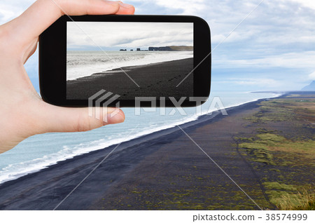 tourist photographs Solheimafjara black sand beach 38574999
