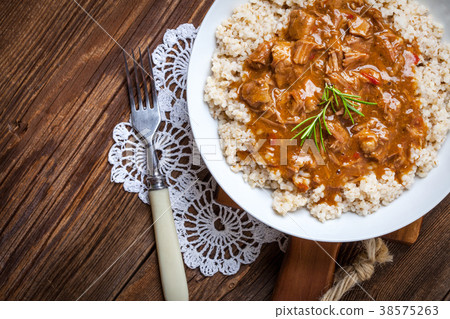 Cooked barley porridge and stew of pork. Cooked barley porridge and stew of pork. 38575263