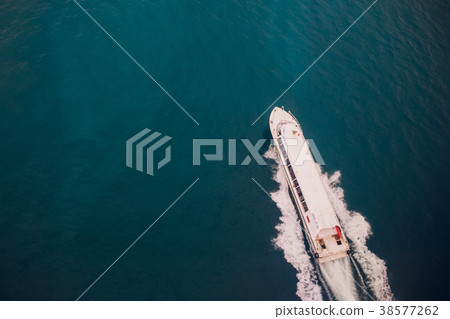 Top view of a boat sailing in the blue sea 38577262