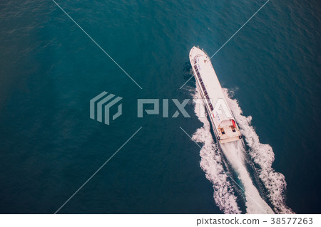 Top view of a boat sailing in the blue sea 38577263