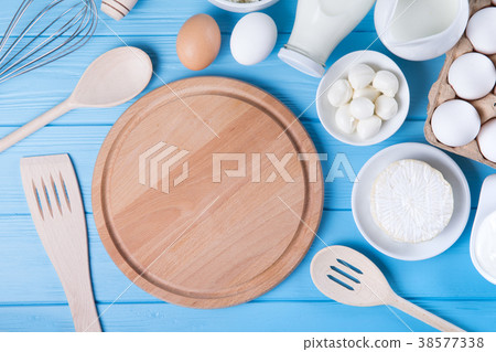 Dairy products on blue wooden table. Dairy products on blue wooden table. 38577338