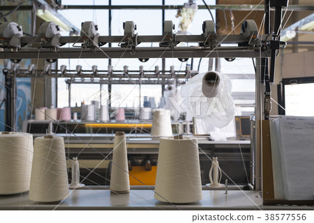 Spools with thread at rewinding machine 38577556