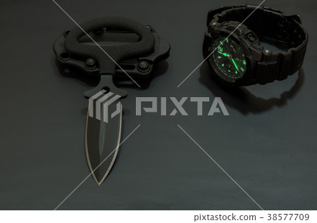 Black knife and black watch on a black background. Black knife and black watch on a black background. 38577709