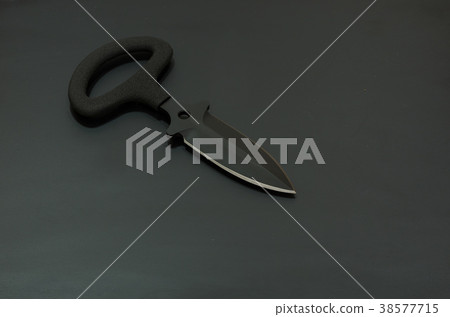 Black knife on a black background. Black knife on a black background. 38577715