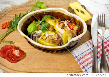 Potatoes baked in a clay pot. Homemade dish. Potatoes baked in a clay pot. Homemade dish. 38577744