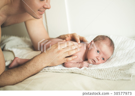 Dad is doing massage to a young son Dad is doing massage to a young son 38577973