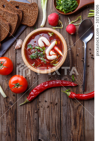 Beet soup in wooden plate with vegetables 38578006
